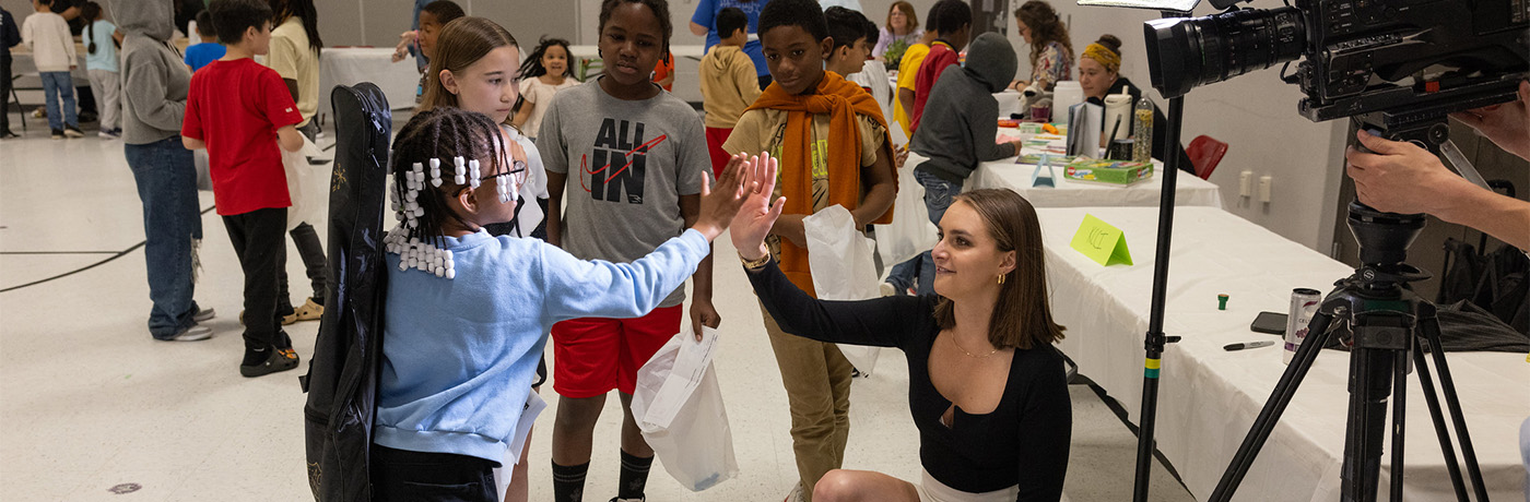 lovejoy student high fiving a volunteer